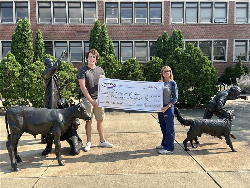Aurora Pharmaceutical DVM scholarship recipient receiving award check