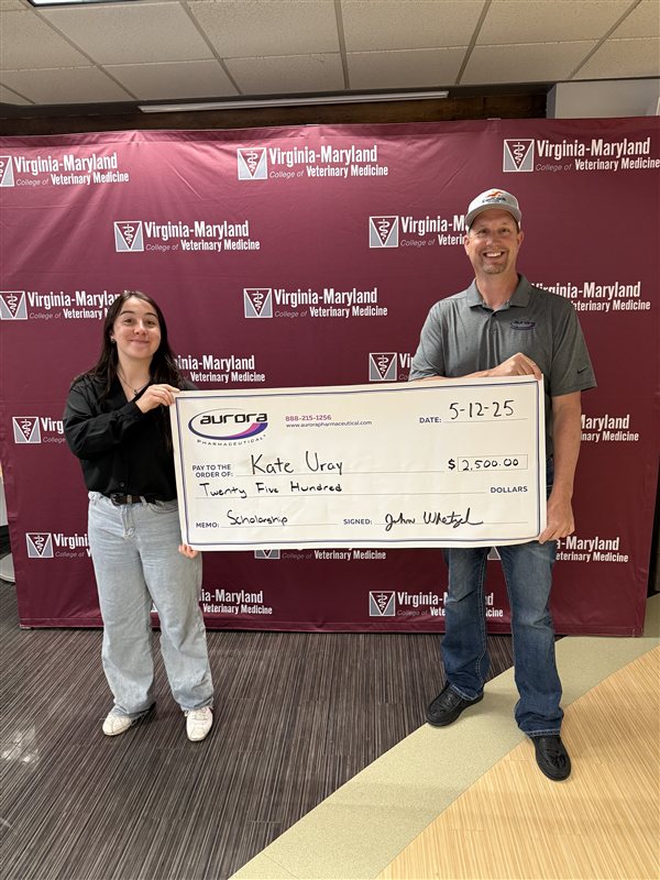 Scholarship recipient Kate Uray receiving award check