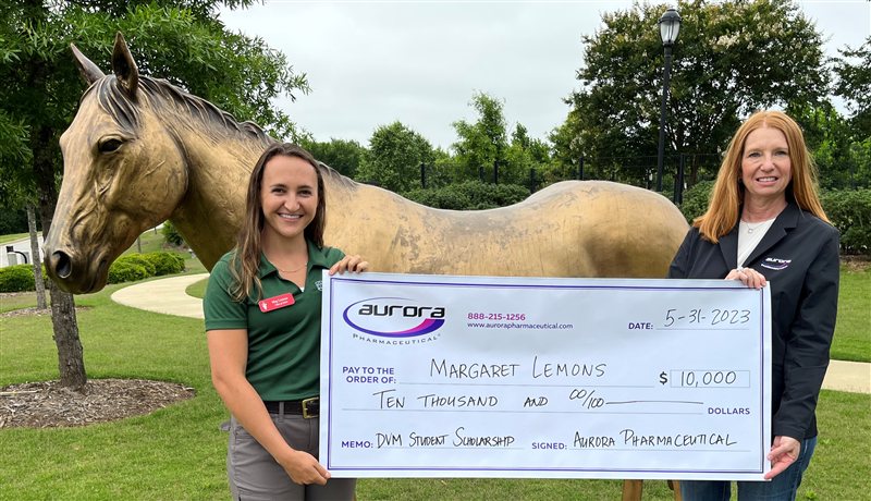 Aurora Pharmaceutical DVM scholarship recipient receiving award check