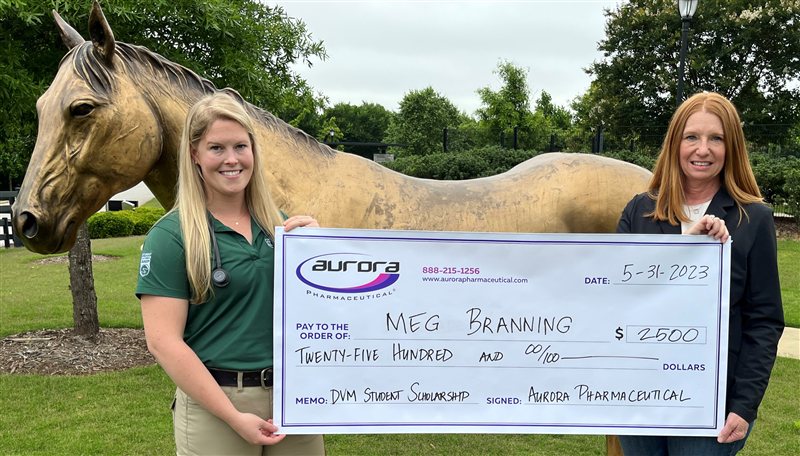 Aurora Pharmaceutical DVM scholarship recipient receiving award check