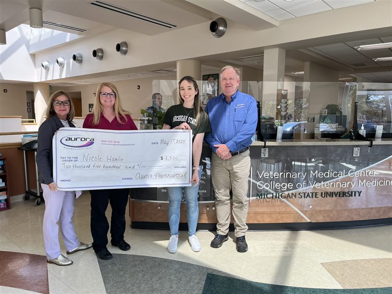 Aurora Pharmaceutical DVM scholarship recipient receiving award check