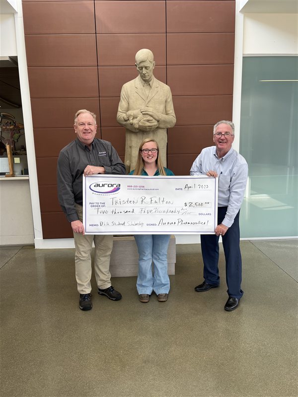 Aurora Pharmaceutical DVM scholarship recipient receiving award check