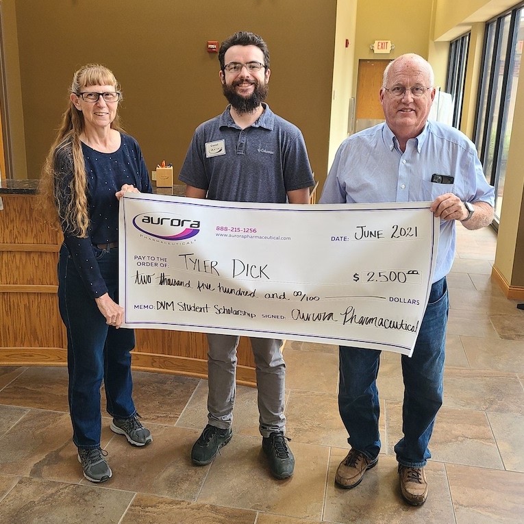 Scholarship recipient Tyler Dick receiving award check